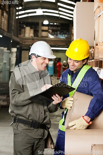 Image of Supervisor Showing Clipboard To Foreman