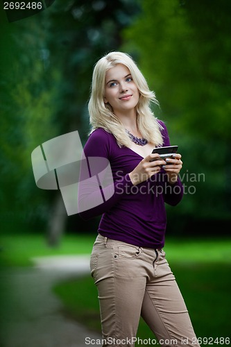 Image of Woman Updating Status on Cell Phone