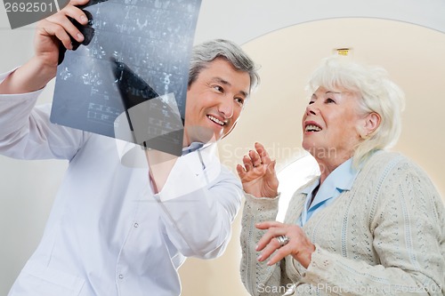 Image of Doctor With Patient Looking At X-ray