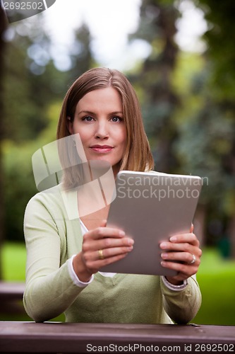 Image of Woman with Digital Tablet Outdoors