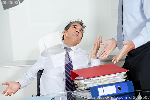 Image of Businessmen Overwhelmed By Load Of Work