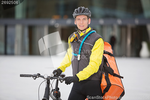 Image of Young Male Cyclist With Courier Delivery Bag