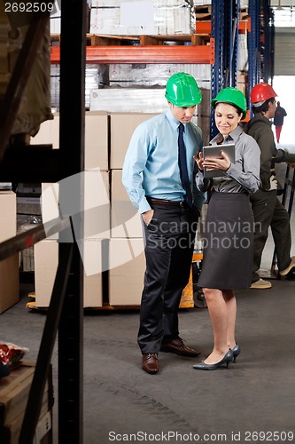Image of Supervisors Using Digital Tablet At Warehouse