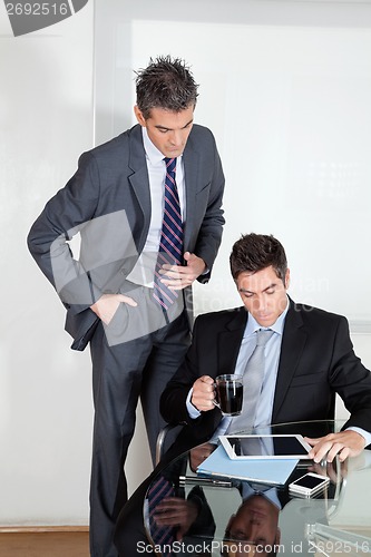 Image of Businessman With Digital Tablet In A Meeting With Colleague