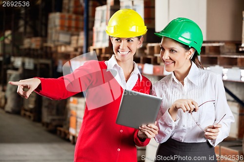 Image of Female Supervisor With Colleague At Warehouse