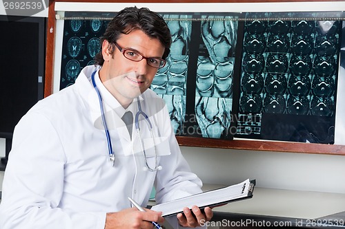 Image of Radiologist At Desk With Clipboard