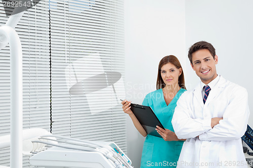 Image of Doctor And Female Assistant In Dental Clinic