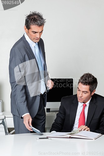 Image of Businessmen calculating finances