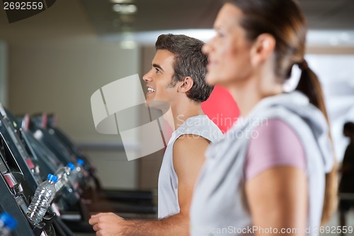 Image of Man And Woman Running On Treadmill