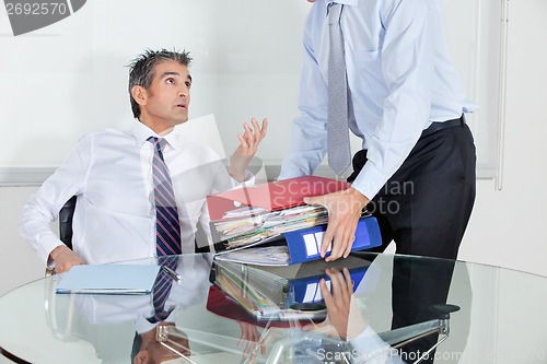 Image of Businessmen Overwhelmed By Load Of Work