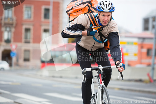 Image of Male Cyclist With Courier Delivery Bag Riding Bicycle