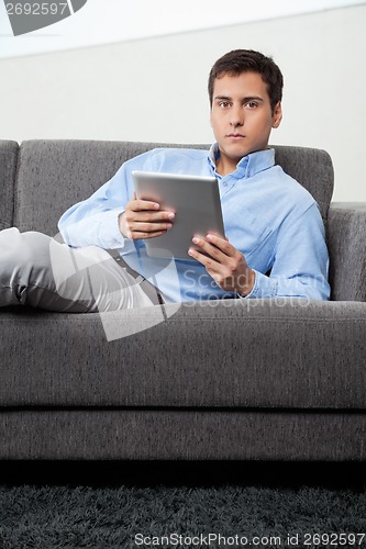 Image of Man Holding Digital Tablet