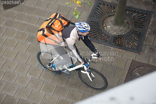 Image of Male Cyclist With Backpack On Sidewalk