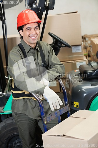 Image of Foreman Leaning On Handtruck At Warehouse