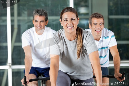 Image of Men And Woman On Exercise Bikes