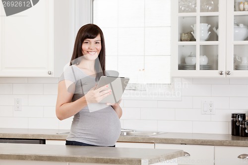 Image of Pregnant Woman with Digital Tablet