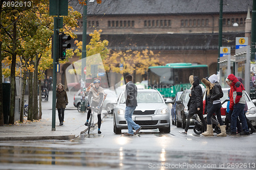 Image of Vehicles Waiting For Commuters To Cross The Street