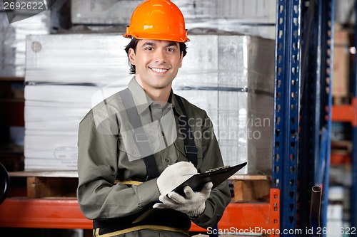 Image of Young Male Supervisor With Clipboard Smiling