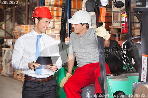 Image of Supervisor Communicating With Forklift Driver