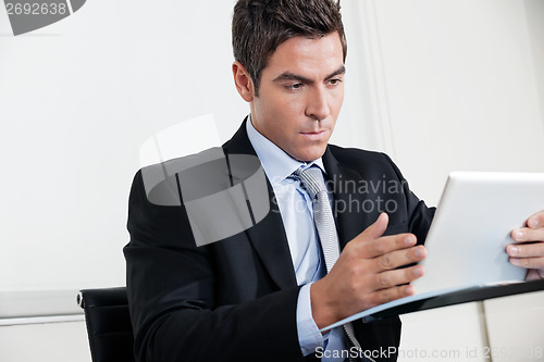 Image of Young Businessman Using Digital Tablet