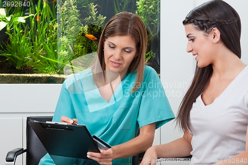 Image of Woman Paying Through Credit Card To Dentist