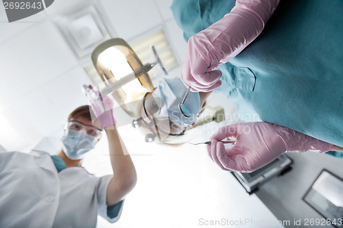 Image of Female Dentist And Assistant Conducting Dental Operation