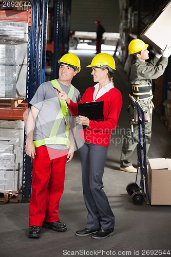 Image of Supervisor Instructing Foreman At Warehouse