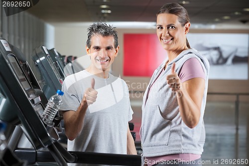 Image of Instructor And Client Showing Thumbs Up Sign In Health Club