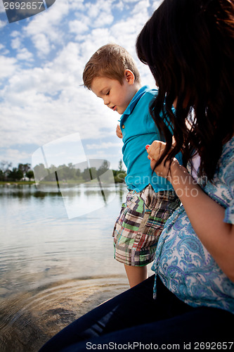 Image of Mother Playing in Water with Son