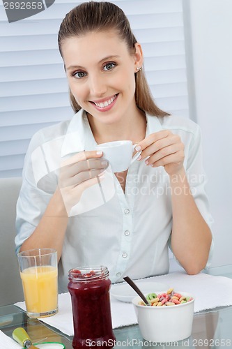 Image of Beautiful Young Woman Having Tea