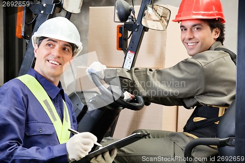 Image of Portrait Of Forklift Driver With Supervisor Writing Notes