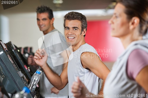Image of Men And Woman Running On Treadmill