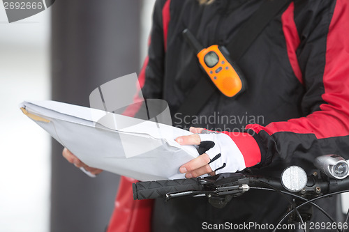 Image of Female Cyclist Holding Courier Package