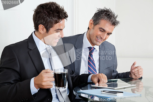 Image of Businessmen Using Digital Tablet In Office