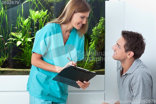 Image of Dentist Taking An Appointment Of Man
