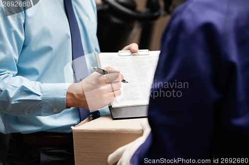 Image of Supervisor Showing Clipboard To Foreman