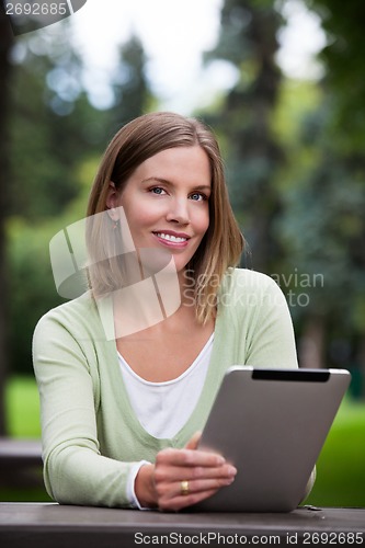 Image of Woman holding Digital Tablet