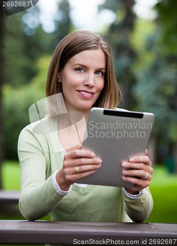 Image of Woman in Park with Digital Tablet