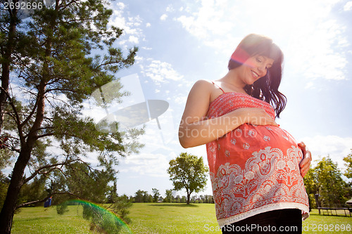 Image of Happy Pregnant Woman in Park