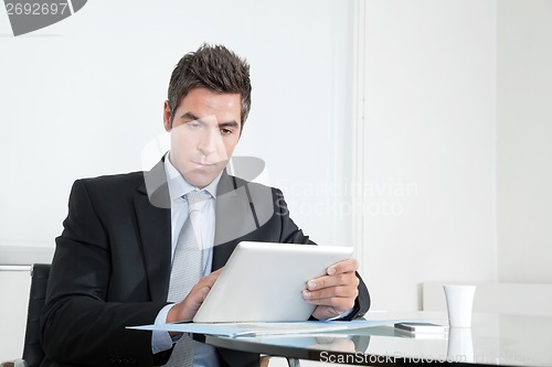Image of Young Businessman With Digital Tablet And Coffee Cup