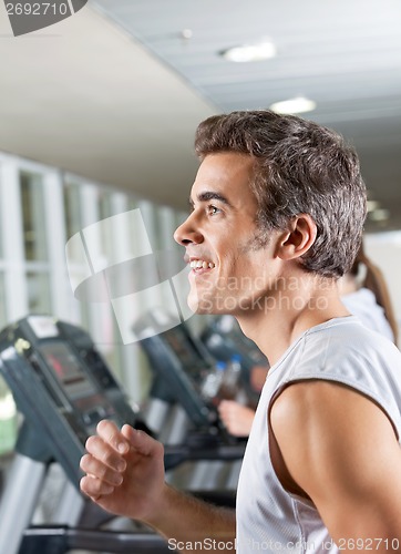 Image of Man And Woman Running On Treadmill