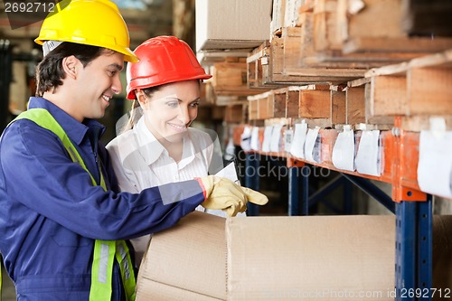 Image of Supervisor And Foreman Checking Stock At Warehouse