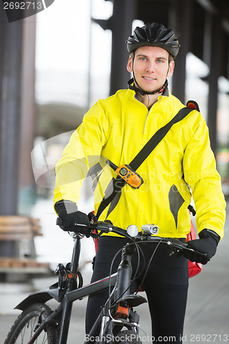 Image of Young Man In Protective Gear With Bicycle