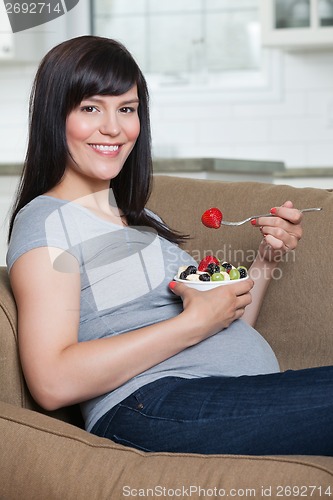 Image of Pregnant Woman Eating Fruit Salad