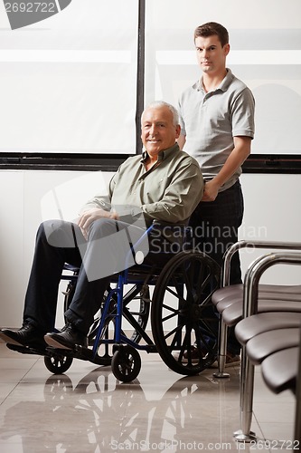 Image of Man With Grandfather Sitting In Wheelchair