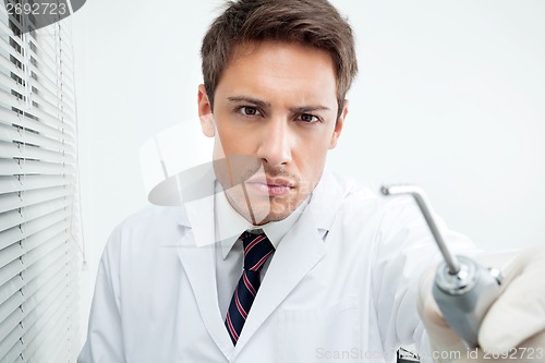 Image of Dentist Holding Water Spraying Tool