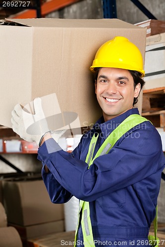Image of Young Foreman Lifting Cardboard Box