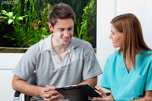 Image of Doctor And Male Patient In Dental Clinic