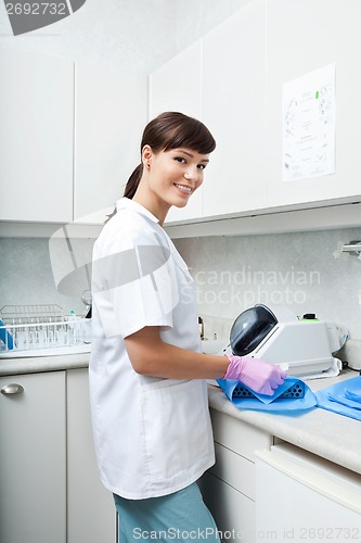 Image of Smiling Female Dentist Working At Clinic