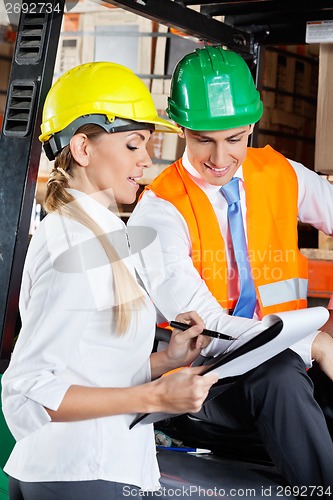 Image of Supervisor Communicating With Colleague At Warehouse